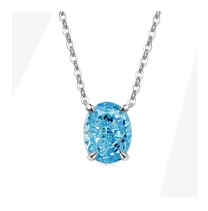 Macro shot of oval light blue gemstone pendant in silver four-prong setting