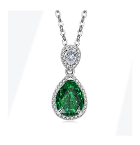 Detail of emerald green teardrop pendant featuring a halo of micro-pave crystals in silver