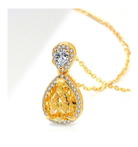 Macro shot of double teardrop pendant necklace with yellow and white pear-cut stones