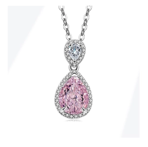 Close-up of double pear-shaped necklace with pink gemstone and white zircon halo pendants