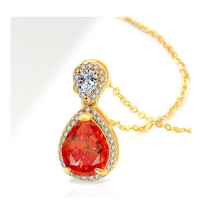 Detailed view of teardrop pendant necklace with orange-red gem and golden chain