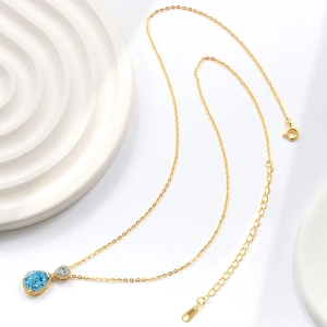 Elegance 925 silver gold-plated necklace with a teardrop-shaped deep blue sapphire pendant