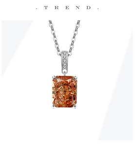 Macro view of champagne rectangular gemstone pendant with pave-set stones on silver chain