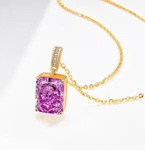 Macro shot of rectangular pink gemstone pendant with gold chain and diamond accents