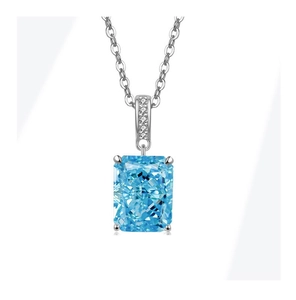 Macro shot of a radiant-cut blue gemstone pendant with small diamond accents on silver chain