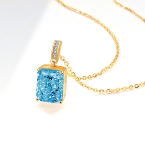 Elegant rectangle blue gemstone pendant necklace with gold chain and white stone accents