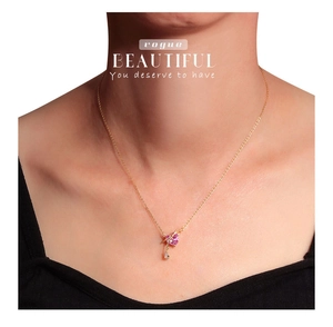 Nahaufnahme einer herzförmigen rosa Edelsteinkette mit Goldkette an einem Modell