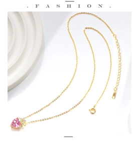 Macro shot of gold-plated S925 sterling silver necklace with pink heart pendant detail
