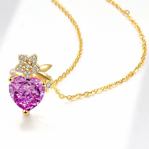 Close-up of heart-shaped purple crystal pendant with gold flower and pearl accents