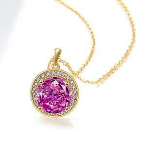 Close-up of golden halo necklace featuring a large round pink gemstone and white diamonds