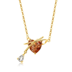 Makroaufnahme der goldenen Herz-Halskette mit Champagner-Edelstein und Schleife