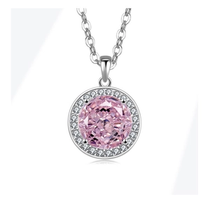 Detailed close-up of a silver pendant necklace with large pink center stone and halo diamonds