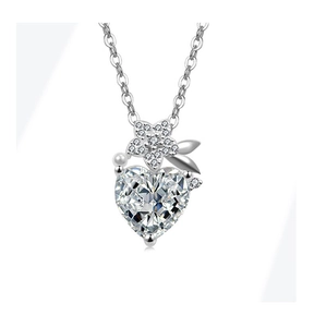 Macro view of heart-shaped zircon pendant necklace with floral silver details