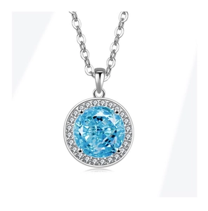 Macro detail of a halo pendant necklace with a blue gemstone and silver O-chain