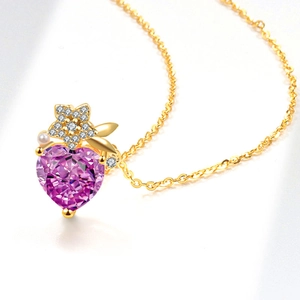 Golden heart necklace with purple gemstone, flower detail, and pearl accent on white background