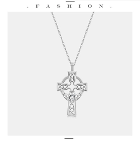Macro view of Celtic Claddagh cross necklace with heart gemstone and woven silver details