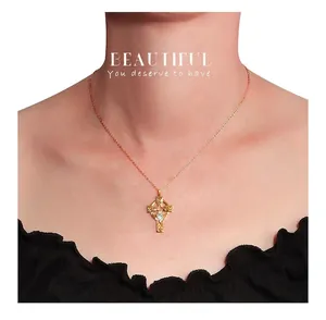 Close-up of golden S925 sterling silver Celtic cross necklace with crystal on neck