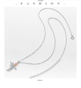 Detail of S925 sterling silver cross necklace with a rose gold flower and zircon stone
