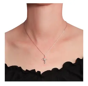 Close-up of S925 silver cross necklace with rose and diamond detail on female neck