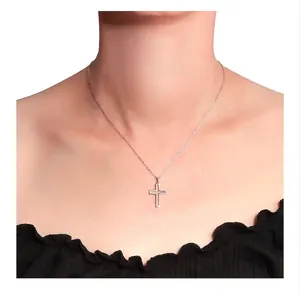 Close-up of minimalist S925 sterling silver hollow cross necklace on neck