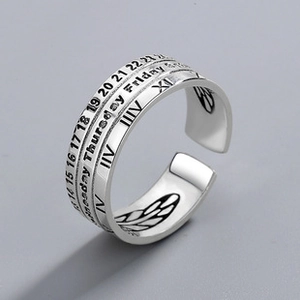 Macro shot of vintage silver calendar ring with engraved numbers and feather inner detail