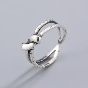 Close-up of double-layered S925 silver knot ring with inner textured band detail