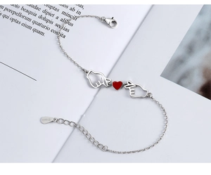 Detail of S925 sterling silver lobster clasp and heart-shaped hand gesture pendant