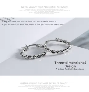 Detailed macro view of 925 sterling silver hoop earrings with twisted rope texture design