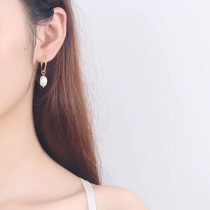 Elegant gold hoop earrings with natural baroque freshwater pearls for women worn on ear