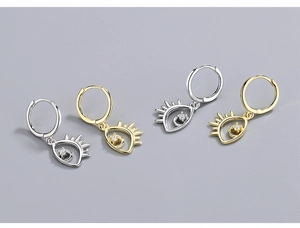 Detail of S925 silver devil eye earrings with cubic zirconia and eyelash accents