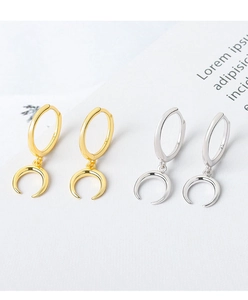 Macro shot showing S925 hallmark on gold and silver crescent moon earrings