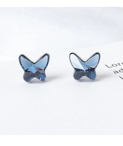 Detailed close-up of light blue butterfly crystal earrings with silver metal edging