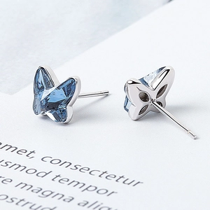 Silver butterfly earrings with light blue Austrian crystal in a minimalist stud design