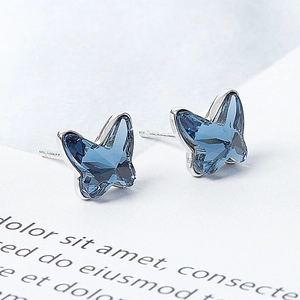 Elegant silver butterfly stud earrings with deep blue Austrian crystal in 45-degree view