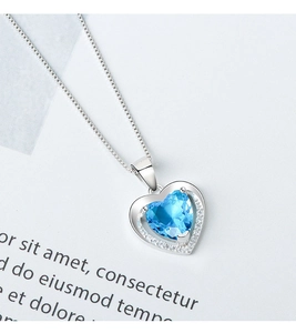 Detailed macro view of heart-shaped blue gemstone pendant with sparkling halo setting