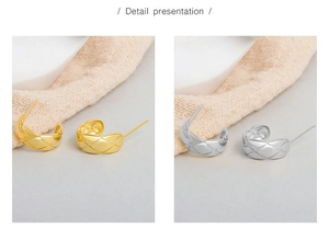 Detail presentation showing quilted rhombus texture on gold and silver C-shape earrings