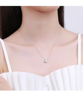Close-up of S925 sterling silver 1-carat moissanite necklace on model collarbone