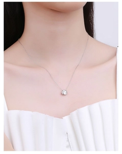 Close-up of S925 sterling silver necklace featuring a 1 carat round moissanite pendant