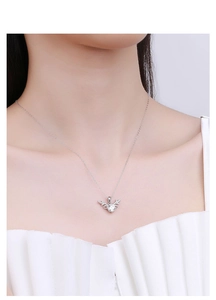 Close-up of S925 silver reindeer necklace with sparkling moissanite on a model