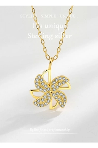 Macro detail of rotating windmill pendant in 925 sterling silver with white cubic zirconia