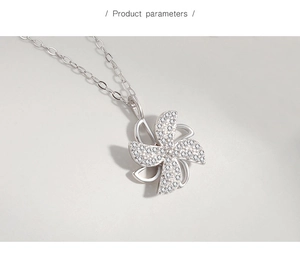 Detail of a rotating windmill pendant with white pavé zircons on a silver chain