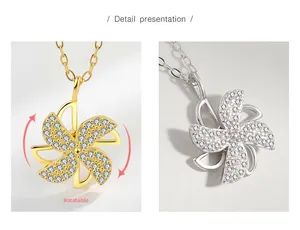 Detail of rotatable windmill pendant necklace in gold and silver with cubic zirconia