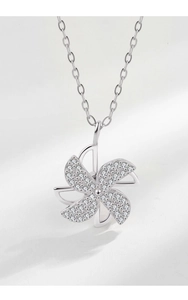 Close-up of rotatable silver windmill pendant with micro-paved cubic zirconia stones