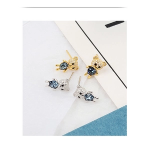 Detailed close-up of 925 silver bear earrings with blue crystals in gold and silver finish