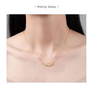 Wearing display of a gold leaf necklace with white zircon pavé and delicate O-chain