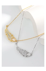 Detail of silver leaf pendant necklaces with zircon feathers and opal water drop stones