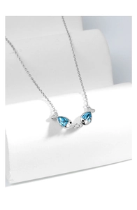 Detail of kissing fish pendant with blue teardrop crystals on silver chain necklace