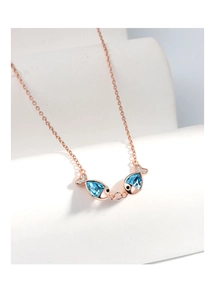 Detailed macro view of S925 silver necklace with blue crystal kissing fish pendants
