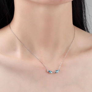 Elegant S925 sterling silver kissing fish necklace with blue Austrian crystals on model