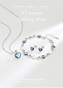 Detailed set of silver Heart of Ocean jewelry with blue crystal necklace and earrings